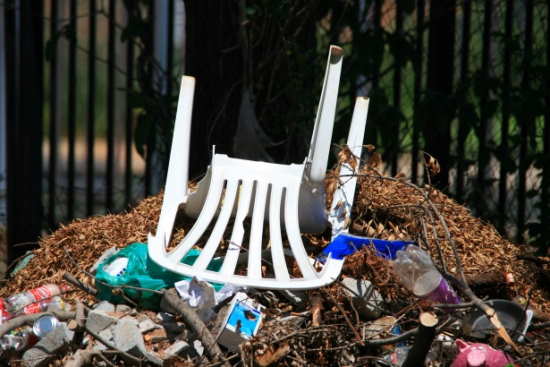 Old broken chair and a rubbish pile in a yard in a Tamworth home